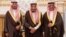 In this photo provided by the Saudi Press Agency, the new Economy and Planning Minister, Mohammad al-Tuwaijri, right and the new National Guard chief, Prince Khalid bin Ayyaf al-Muqrin, left, pose for a photo with King Salman during a swearing in ceremony, in Riyadh, Saudi Arabia, Nov. 6, 2017. The king has sworn in new officials to take over from a powerful prince and former minister believed to be detained in a large-scale sweep that has upended longstanding traditions. 
