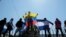 FILE - Anti-government protesters hold flags and shout slogans to riot police during a demonstration against Nicaraguan President Daniel Ortega's government in Managua, Nicaragua, March 30, 2019. 