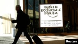 FILE - An attendee leaves the Congress Hall during the World Economic Forum (WEF) annual meeting in Davos, Switzerland, Jan. 20, 2017.