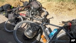 FILE - Bicycles are left where four tourists were killed when a car rammed into a group of foreigners on bicycles, south of the capital of Dushanbe, Tajikistan, July 29, 2018.