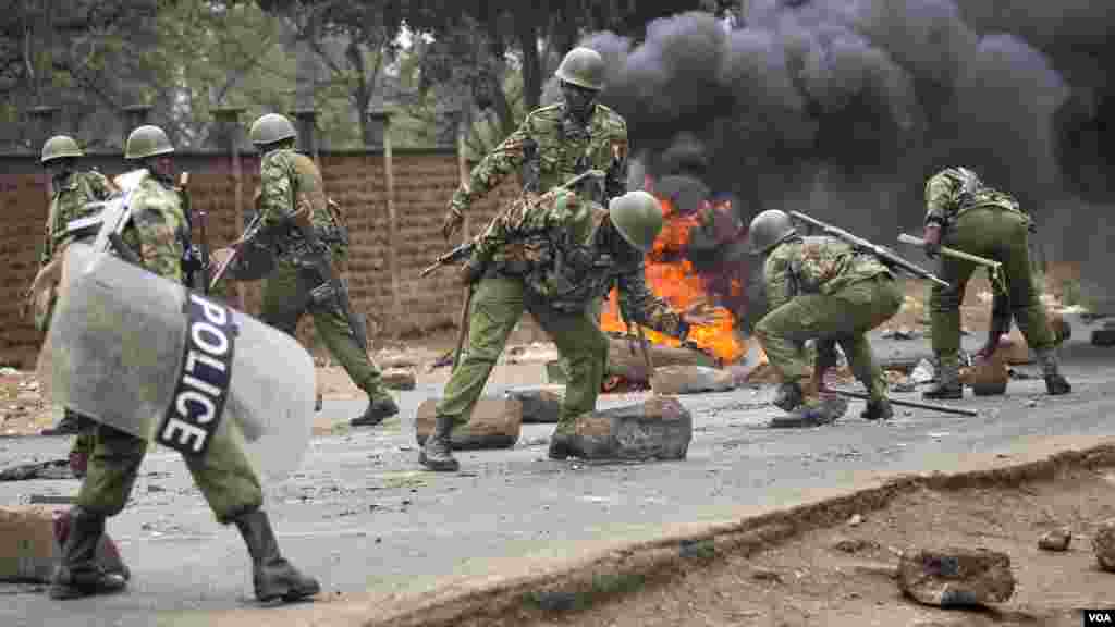 Les forces de sécurité kényanes retirent les barricades dans une rue bloquée par les partisans de Raila Odinga à Nairobi le 9 août 2017.