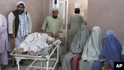 A wounded man is transported at a hospital after a roadside bomb blast in the Panjwai district of Kandahar May 24, 2011