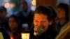 Teresa Welter cries as she holds a candle at a vigil for mudslide victims in Arlington, Washington, March 25, 2014.