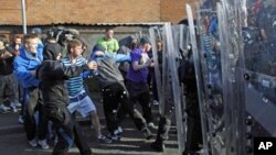 Youths attack police in Ardoyne in Belfast, Northern Ireland. Police firing plastic bullets and powerful water cannons forced Catholic militants away from a disputed Belfast road Tuesday as Northern Ireland's annual day of Protestant marches reached a fie