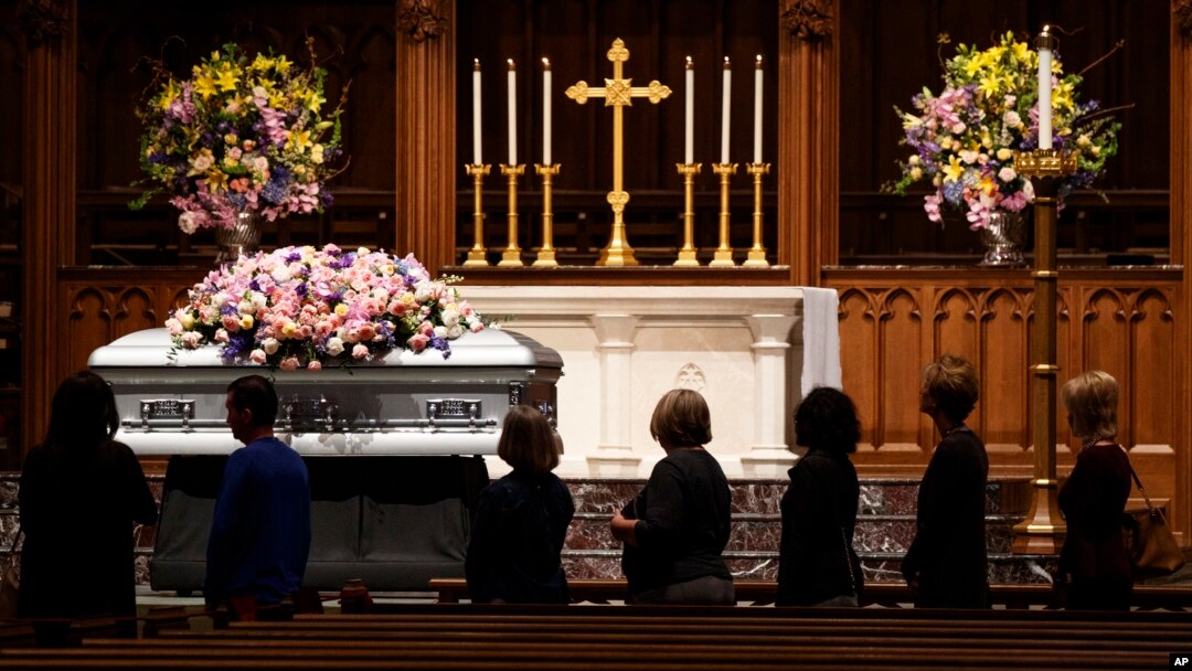 Members of the public walk past the casket of former first lady Barbara Bush at St. Martin's church, April 20, 2018, in Houston.
