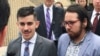 FILE - ACLU lawyer Chase Strangio, left, and plaintiff Joaquin Carcano address reporters after a hearing, June 25, 2018, in Winston-Salem, N.C., 