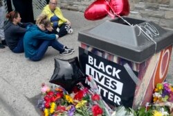 Mourners gather near the site where a man died in police custody Monday night in Minneapolis, May 26, 2020.