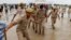 Police officers walk at the site where believers had gathered for a Hindu religious congregation, following which a stampede occurred, in Hathras district of the northern state of Uttar Pradesh, India, July 3, 2024. 