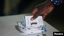 An election commission worker counts votes at a polling station in Dakar, Senegal, March 24, 2024. 