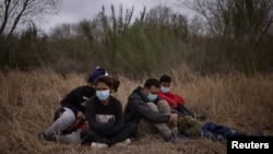 Asylum-seeking unaccompanied minors from Central America are separated from other migrants by U.S. Border Patrol agents after crossing the Rio Grande river into the United States from Mexico, March 14, 2021. 