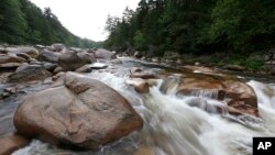 FILE - The Wassataquoik Stream flows through Township 3, Range 8, Maine, on land owned by environmentalist Roxanne Quimby, the founder of Burts Bees, Aug. 4, 2015.