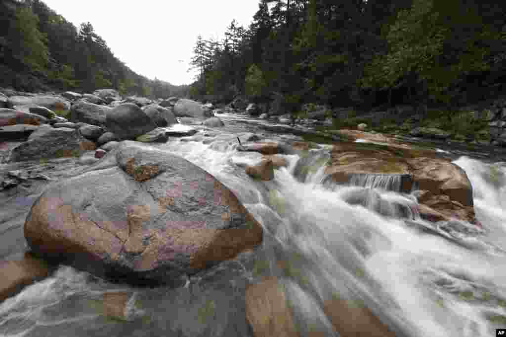 FILE - The Wassataquoik Stream flows through Township 3, Range 8, Maine, on land owned by environmentalist Roxanne Quimby, the founder of Burts Bees, Aug. 4, 2015. It is now part of the Katahdin Woods and Waters National Monument, founded on Aug. 24, 2016.