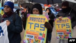 FILE - Demonstrators participate in the March For TPS Justice as they rally outside the White House in Washington, Feb. 12, 2019.