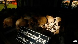 In this photo taken, May 20, 2013, hundreds of former Khmer Rouge victims' bone and skulls are displayed in a memorial at Choeung Ek "Killing Field" in Phnom Penh, Cambodia.