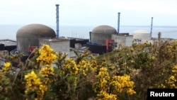 FILE - Three reactors make up the Flamanville 3 nuclear power plant in Flamanville, France, on April 25, 2024, with the European Pressurized Reactor at far right. France connected the EPR to the power grid for the first time on Dec. 21, 2024.