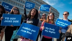 FILE - Activists with Planned Parenthood demonstrate in support of a pregnant 17-year-old being held in a Texas facility for unaccompanied immigrant children to obtain an abortion, Oct. 20, 2017. A federal court in Washington told the Trump administration