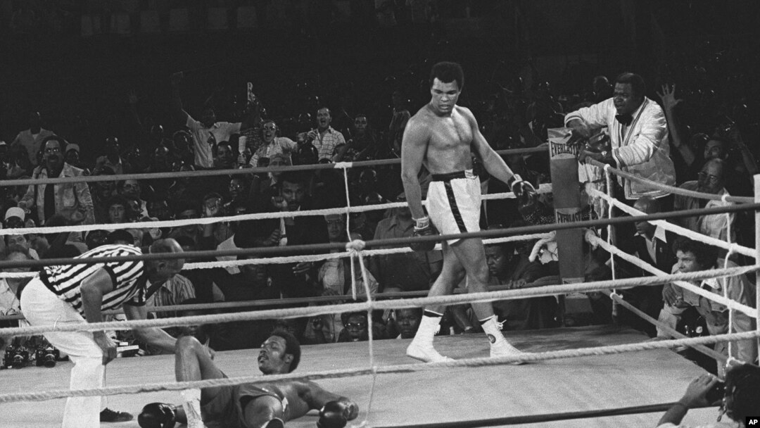 Referee Zack Clayton counts out George Foreman in round 8 of a title bout with Muhammad Ali, in Kinshasa, Zaire, Oct. 30, 1974. 