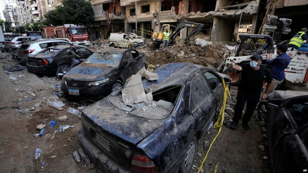 Damaged cars at the site of Friday's Israeli strike in Beirut's southern suburbs, Sept. 21, 2024. 