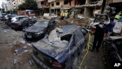 Damaged cars at the site of Friday's Israeli strike in Beirut's southern suburbs, Sept. 21, 2024. 