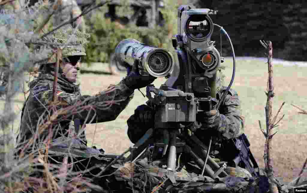 Soldiers from German Bundeswehr Armed Forces with the 371st armored infantry battalion take position with a MILAN anti-tank rocket launcher during a media day at the barracks in Marienberg.