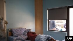 FILE - A TB patient sleeps in his room at the Sizwe Tropical Diseases Hospital in Johannesburg, South Africa, August 5, 2019. 