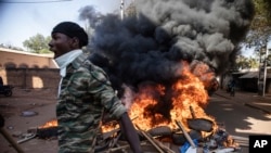 Protestors take to the streets of Burkina Faso's capital Ouagadougou Saturday Nov. 27, 2021, calling for President Roch Marc Christian Kabore to resign. 