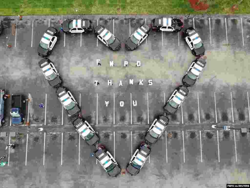The Fort Myers Police Department makes heart out of police cars to thank health workers at Lee Memorial Hospital, in Fort Myers, Florida, in this picture obtained from social media.