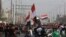 FILE - Anti-government protesters rally outside the provincial council building in Basra, Iraq, May 25, 2021. Iraqis have taken to the streets in several of the country's cities protesting cuts in electricity supplies during scorching summer temperatures.