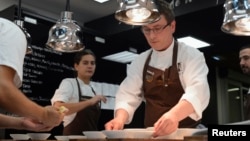 FILE - Basque chef Andoni Aduriz (C) prepares a dish in the kitchen at his restaurant Mugaritz in Renteria, near San Sebastian, Spain, June 3, 2012. 