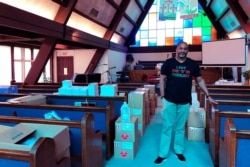 Earle Fisher, a pastor and civil rights activist, poses inside Abyssinian Missionary Baptist Church, July 12, 2020, in Memphis, Tenn. Fisher is a plaintiff in a lawsuit seeking to open up mail-in voting to all eligible voters in Tennessee.