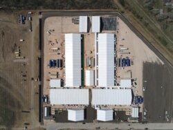 FILE - Soft-sided structures, constructed in anticipation of a surge in migration at a U.S. Customs and Border Protection temporary processing facility, are seen in Donna, Texas, Jan. 29, 2021. (U.S. Border Patrol/Handout via Reuters)