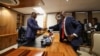 Former President of Botswana Mokgweetsi Masisi, right, hands over his office to newly elected President Duma Boko at the Office of the President, Gaborone, Botswana, Nov. 4, 2024. 