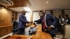 Former President of Botswana Mokgweetsi Masisi, right, hands over his office to newly elected President Duma Boko at the Office of the President, Gaborone, Botswana, Nov. 4, 2024. 