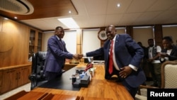 Former President of Botswana Mokgweetsi Masisi, right, hands over his office to newly elected President Duma Boko at the Office of the President, Gaborone, Botswana, Nov. 4, 2024. 