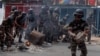 Riot police officers clear a barricade after dispersing supporters of the opposition parties during a protest ahead of the forthcoming first round of Madagascar's presidential election in Antananarivo