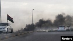 FILE - Smoke rises during heavy clashes between rival factions in Tripoli, Libya, May 27, 2017.