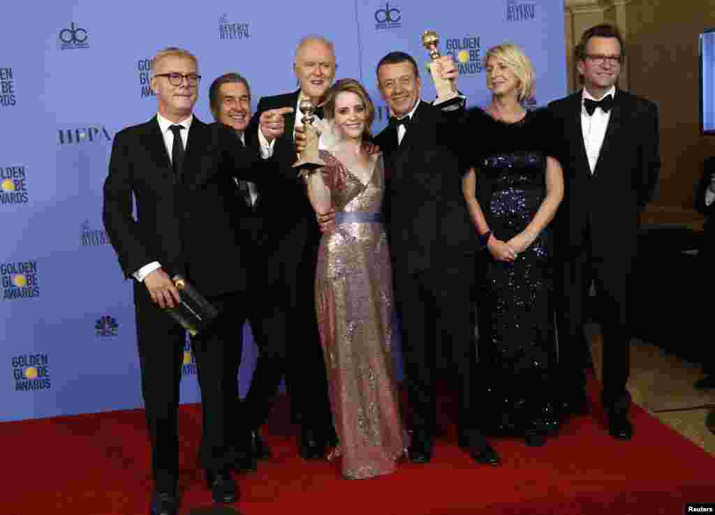 The cast and crew of "The Crown" pose together after winning the Golden Globe award for Best Television Series - Drama as star Claire Foy holds her award for Best Performance by an Actress In A Television Series - Drama, Jan. 8, 2017.