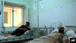 Injured workers of HALO Trust de-mining organization are treated at a hospital in northern Baghlan province, Afghanistan, June 9, 2021.