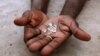 An illegal diamond dealer from Zimbabwe displays diamonds for sale in Manica, near the border with Zimbabwe, September 19, 2010.