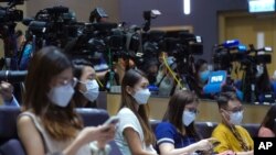 Journalists wearing face masks to help curb the spread of the coronavirus attend a press conference by Hong Kong Chief Executive Carrie in Hong Kong, Aug. 17, 2021.