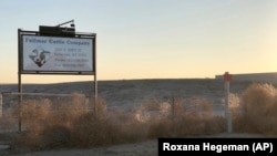 This Dec. 11, 2017 photo, shows a sign outside the Fullmer Cattle Co. in Syracuse, Kan. (AP Photo/Roxana Hegeman)