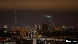 Ukrainian service personnel use a searchlight as they search for drones in the sky over the city during a Russian drone strike, amid Russia's attack on Ukraine, in Kyiv, Ukraine Oct. 25, 2024.