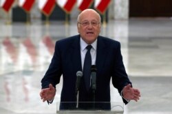 FILE - Lebanese Prime Minister-designate Najib Mikati, speaks to journalists after his meeting with Lebanese President Michel Aoun, at the Presidential Palace in Baabda, east of Beirut, Lebanon, July 26, 2021.