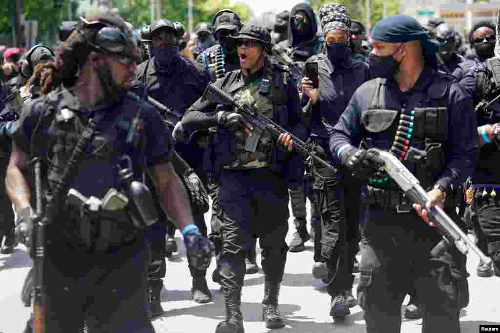 Grand Master Jay, center, leader of an all-Black militia group called NFAC, leads his followers on a march during an armed rally in Louisville, Kentucky, July 25, 2020.