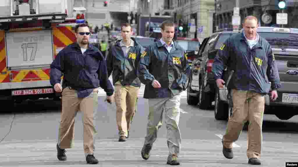 Federal Bureau of Investigation (FBI) agents arrive at the scene after explosions near the finish line of the Boston Marathon in Boston, Massachusetts April 15, 2013.
