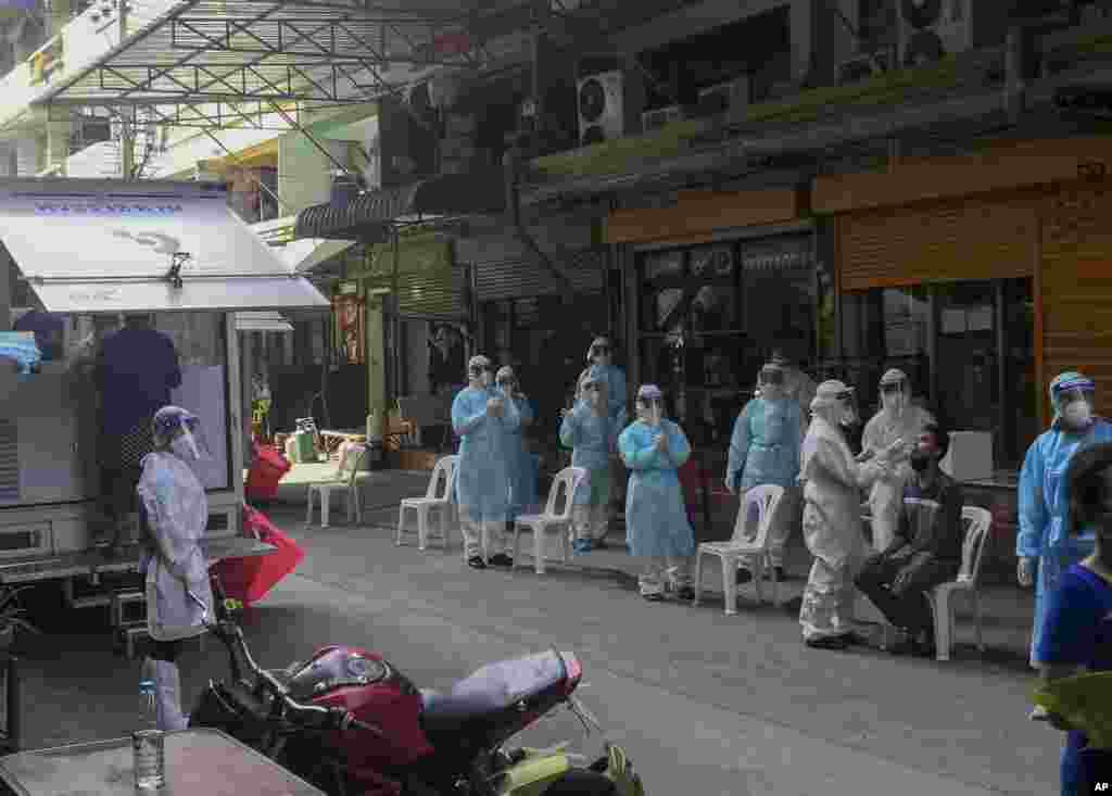 ထိုင်းနိုင်ငံ စမွတ်ဆာခွန်းခရိုင်က ပုစွန်ဈေးမှာ ကိုဗစ်စစ်ဆေးဖို့ ပြင်ဆင်နေတဲ့ ကျန်းမာရေးဝန်ထမ်းများ။ (ဒီဇင်ဘာ ၂၀၊ ၂၀၂၀)