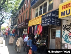 Shops nearby the Brooklyn mosque sell traditional Islamic clothing, books and foods. (M. Besheer/VOA)
