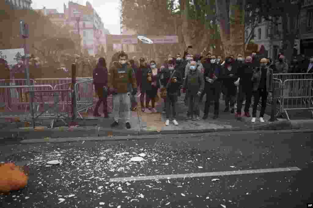Restaurant and bar owners toss plates and glasses at a demonstration against restaurant and bar closures in Marseille, southern France, Friday Oct. 2, 2020