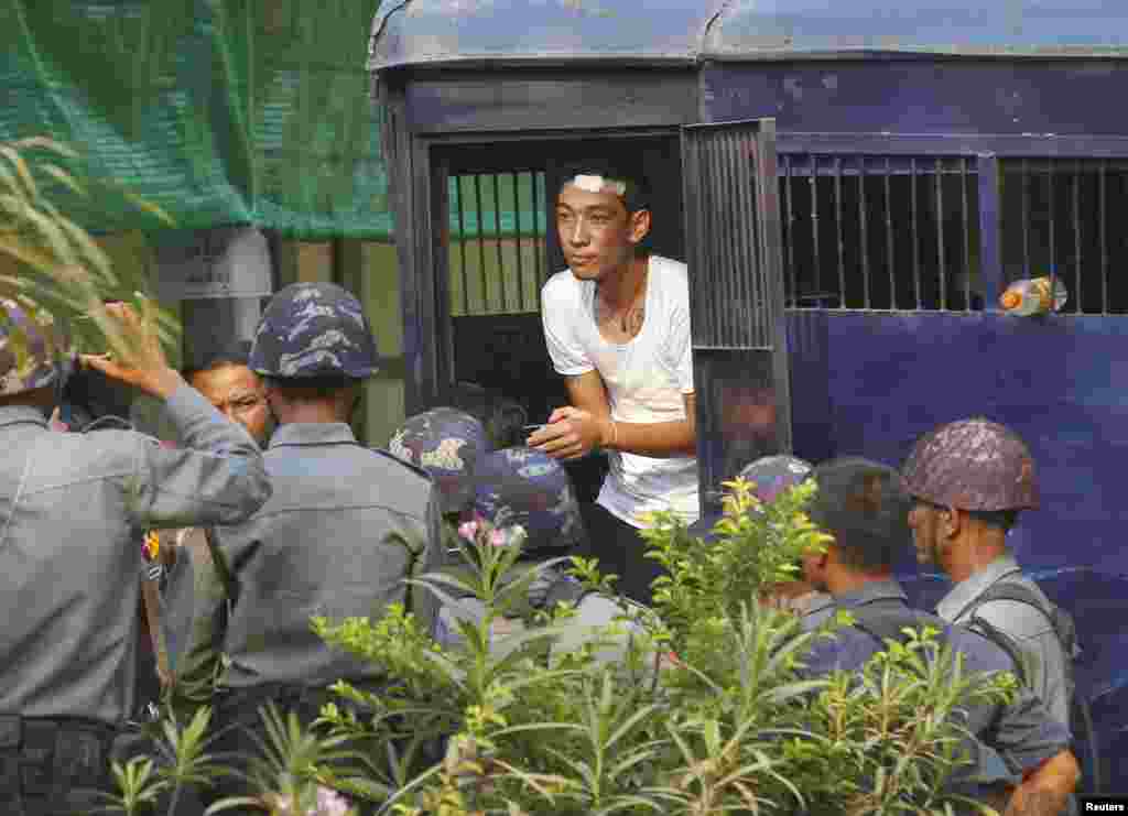 A student protester exits a prison vehicle, as he arrives at a courthouse in Letpadan, March 11, 2015.