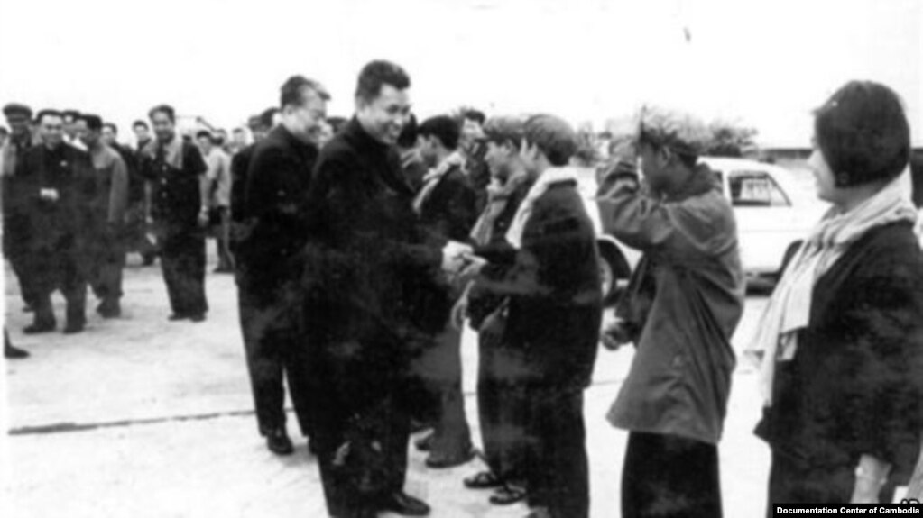 In this undated photo provided by Documentation Center of Cambodia, the late Khmer Rouge leader Pol Pot, center, greets Khmer Rouge cadre in Phnom Penh airport, Cambodia. (Courtesy of DC-Cam) 